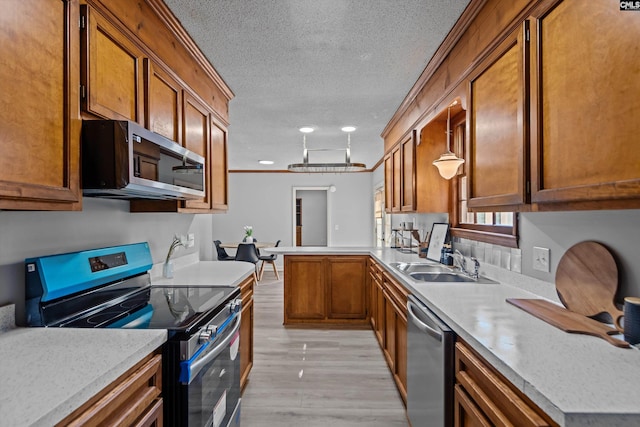 3040 Barnes Springs Rd, Columbia, SC 29204 - kitchen with appliances with stainless steel finishes, a sink, brown cabinetry, a textured ceiling, and a peninsula