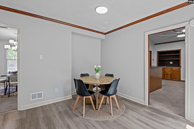 3040 Barnes Springs Rd, Columbia, SC 29204 - dining room featuring ornamental molding, light wood finished floors, baseboards, ceiling fan, and a chandelier