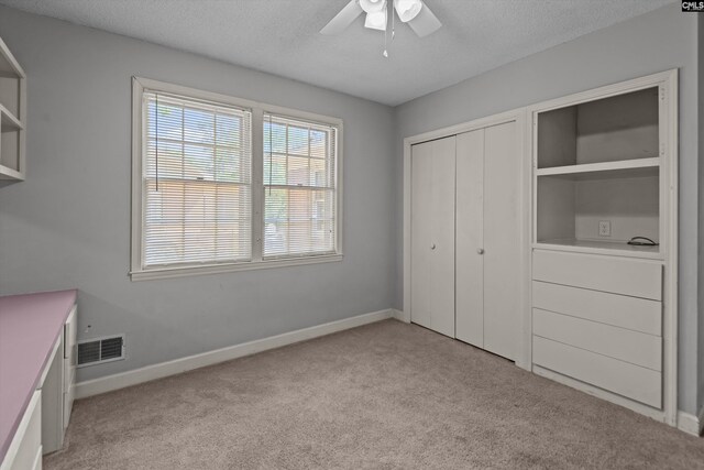 3040 Barnes Springs Rd, Columbia, SC 29204 - unfurnished bedroom featuring light carpet, a closet, a textured ceiling, baseboards, and ceiling fan
