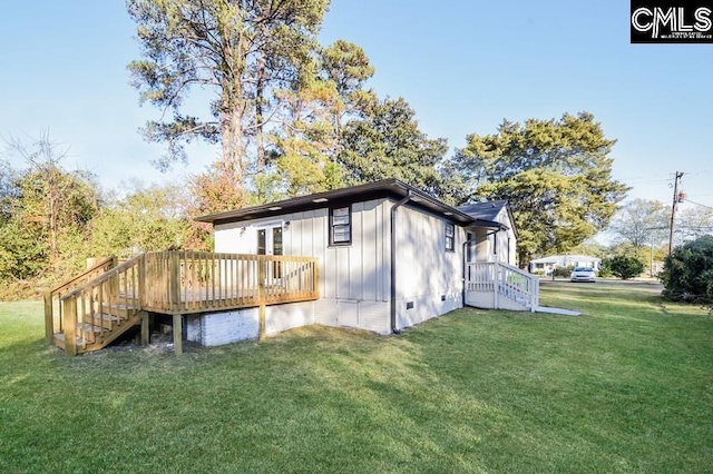 1527 Burnside Ave, Columbia, SC 29209 - view of side of home with board and batten siding, a yard, a deck, and stairway