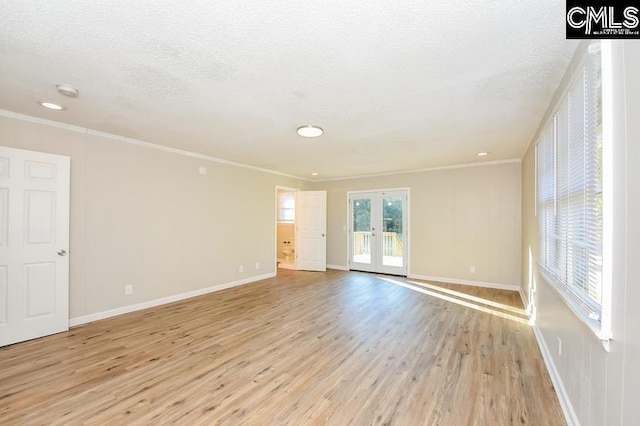1527 Burnside Ave, Columbia, SC 29209 - empty room featuring light wood-style floors, french doors, crown molding, baseboards, and a textured ceiling