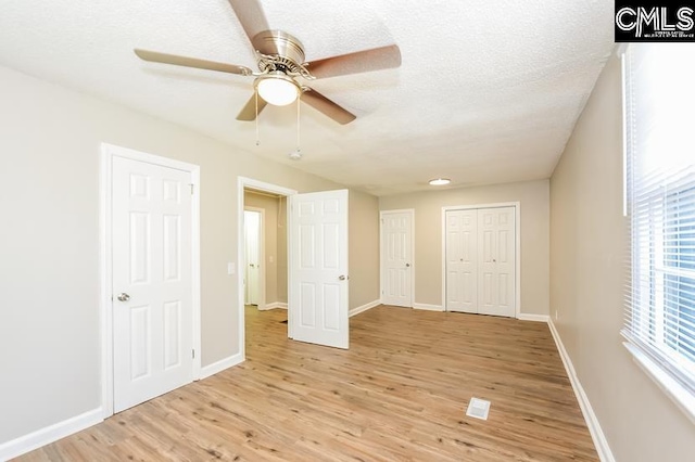 1527 Burnside Ave, Columbia, SC 29209 - unfurnished bedroom featuring light wood-style flooring, baseboards, and ceiling fan
