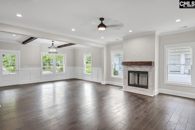 1409 Woodrow St, Columbia, SC 29205 - unfurnished living room featuring a premium fireplace, ceiling fan, wainscoting, beam ceiling, and dark wood-type flooring