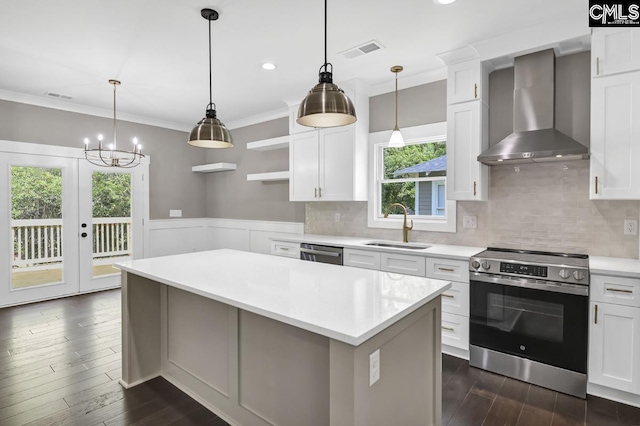 1409 Woodrow St, Columbia, SC 29205 - kitchen with appliances with stainless steel finishes, wall chimney range hood, a sink, dark wood-style flooring, and light countertops