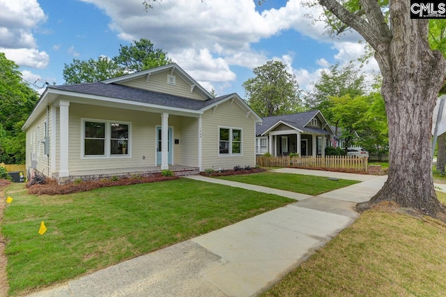 1409 Woodrow St, Columbia, SC 29205 - bungalow-style house featuring covered porch, a shingled roof, and central air condition unit