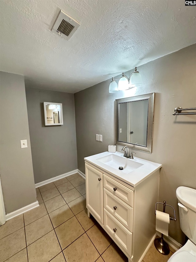 1201 Old Manor Rd, Columbia, SC 29210 - bathroom featuring tile patterned flooring, a textured ceiling, toilet, vanity, and baseboards