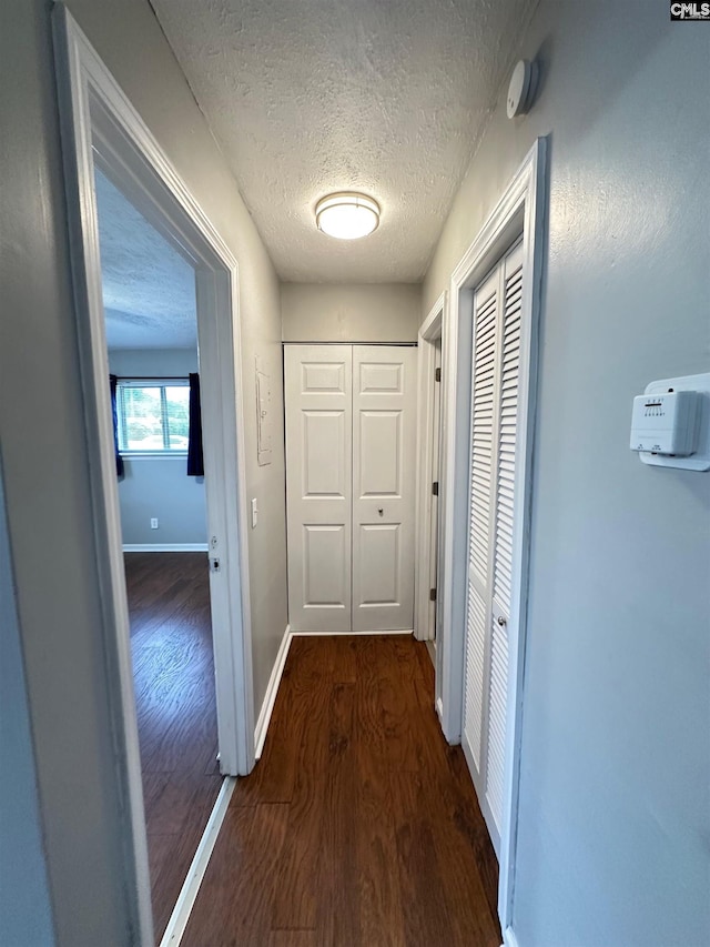 1201 Old Manor Rd, Columbia, SC 29210 - hallway with dark wood-style floors, a textured ceiling, and baseboards