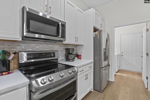 kitchen with appliances with stainless steel finishes, light wood-style floors, white cabinets, and decorative backsplash