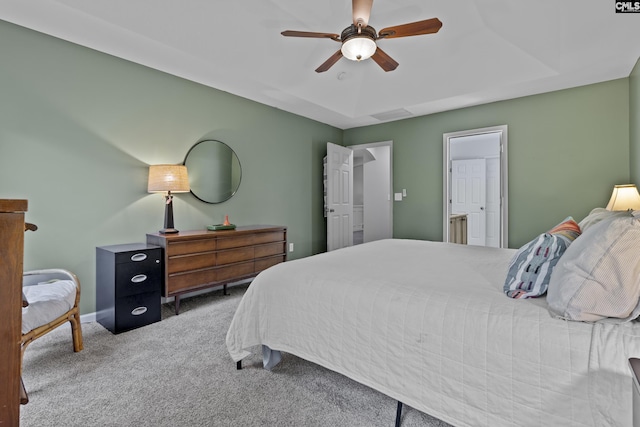 carpeted bedroom with ceiling fan and baseboards