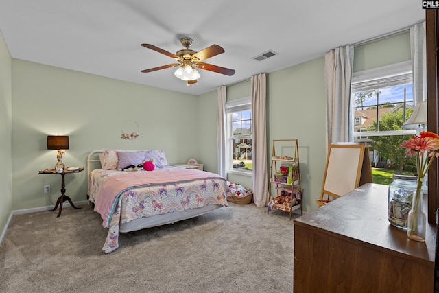 carpeted bedroom featuring ceiling fan and baseboards