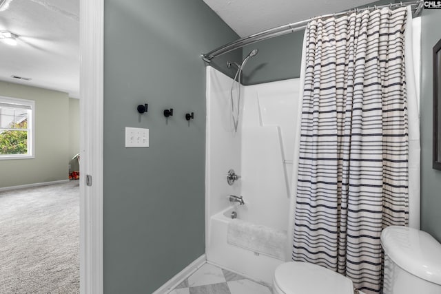 full bathroom with toilet, baseboards, shower / bath combo with shower curtain, marble finish floors, and a textured ceiling