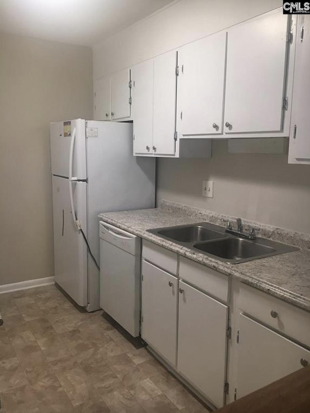 321 Cambout St, Columbia, SC 29210 - kitchen featuring white dishwasher, a sink, white cabinets, light floors, and baseboards