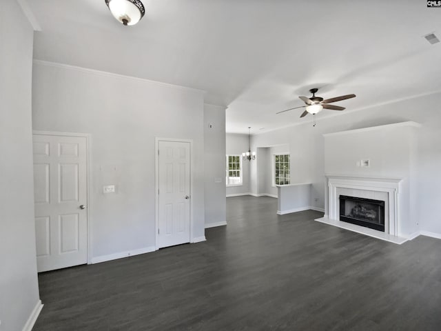 unfurnished living room with a ceiling fan, dark wood finished floors, baseboards, and a fireplace