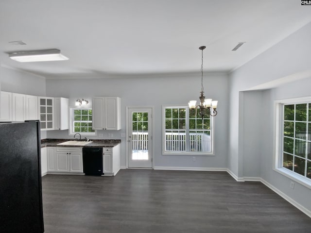kitchen with black appliances, a sink, a chandelier, dark countertops, and dark wood finished floors