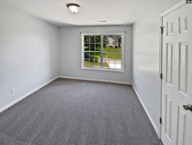 carpeted empty room with baseboards