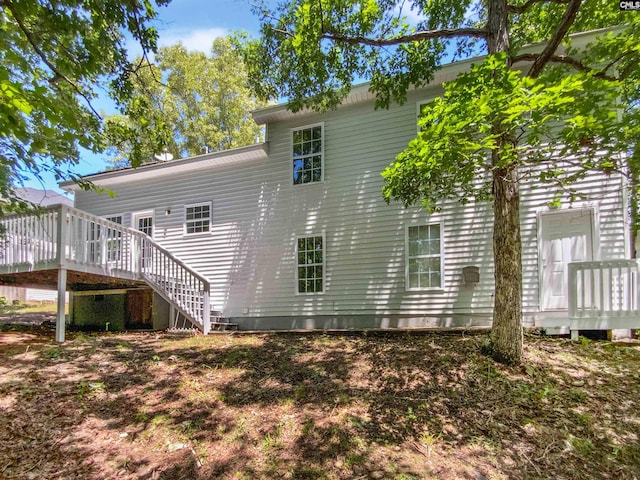 back of house with a deck and stairs