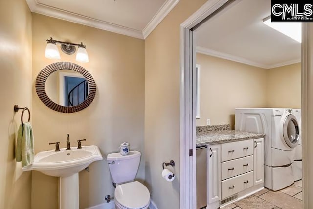half bathroom featuring crown molding, tile patterned flooring, toilet, and washer / clothes dryer
