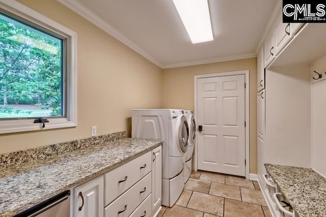 washroom with independent washer and dryer, crown molding, cabinet space, and baseboards