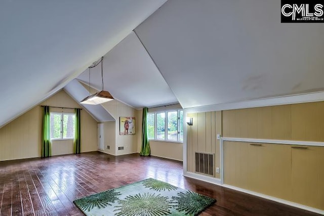 bonus room with healthy amount of natural light, wood finished floors, and vaulted ceiling