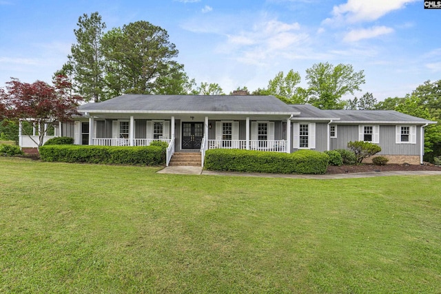 single story home featuring covered porch and a front yard