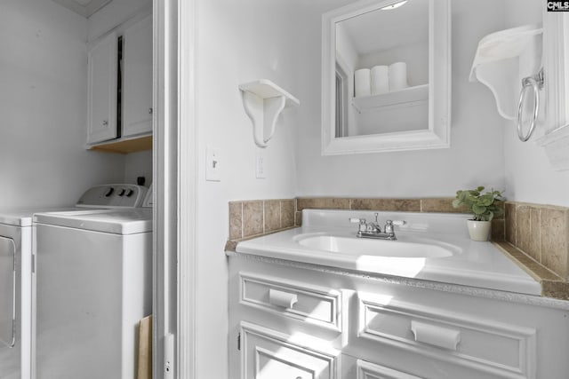 bathroom featuring washer and clothes dryer and vanity