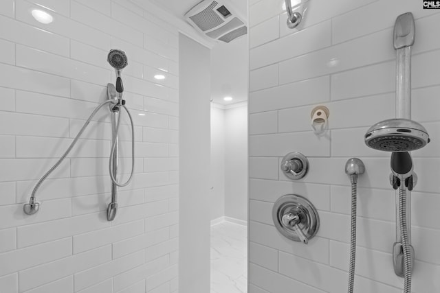 full bath featuring marble look tile flooring and a tile shower