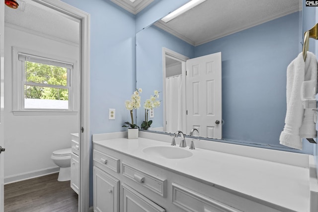 full bathroom with ornamental molding, toilet, wood finished floors, vanity, and baseboards