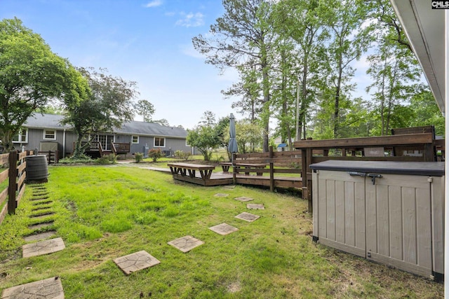 view of yard featuring a jacuzzi and a deck