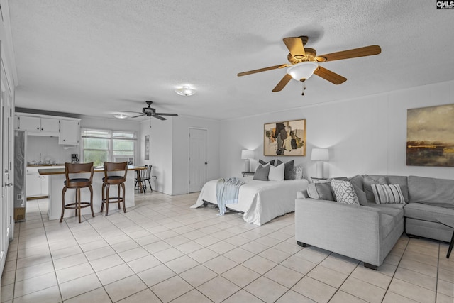 bedroom featuring a textured ceiling and light tile patterned floors