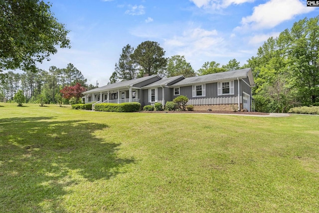 single story home featuring board and batten siding and a front lawn
