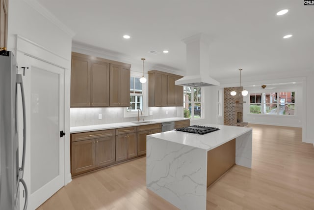 1020 W Confederate Ave, Columbia, SC 29201 - kitchen featuring stainless steel appliances, a sink, island exhaust hood, light wood-type flooring, and tasteful backsplash
