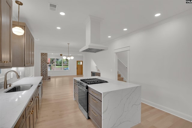 1020 W Confederate Ave, Columbia, SC 29201 - kitchen with gas stove, a sink, light wood-style flooring, custom range hood, and decorative light fixtures