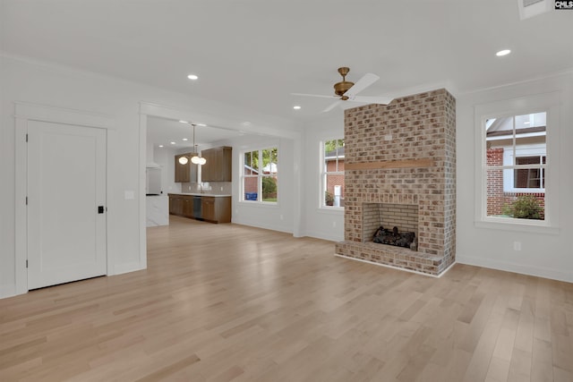 1020 W Confederate Ave, Columbia, SC 29201 - unfurnished living room featuring crown molding, a brick fireplace, a ceiling fan, light wood-style flooring, and baseboards
