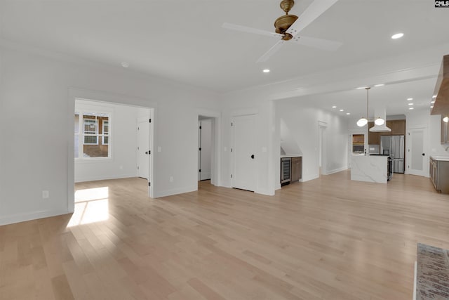 1020 W Confederate Ave, Columbia, SC 29201 - unfurnished living room with a ceiling fan, light wood-style flooring, baseboards, recessed lighting, and crown molding