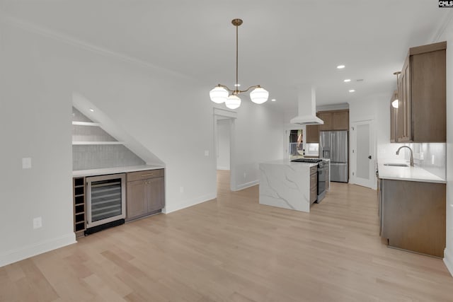 1020 W Confederate Ave, Columbia, SC 29201 - kitchen featuring wine cooler, a sink, appliances with stainless steel finishes, wall chimney range hood, and a kitchen island