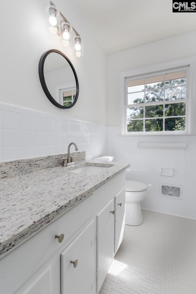 3901 Overdale Dr, Columbia, SC 29223 - bathroom with tile walls, vanity, toilet, and a wainscoted wall