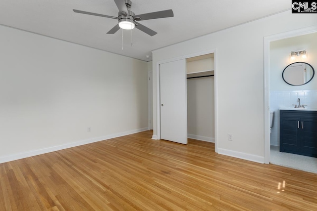 3901 Overdale Dr, Columbia, SC 29223 - unfurnished bedroom with a sink, light wood-style flooring, ensuite bathroom, baseboards, and a closet