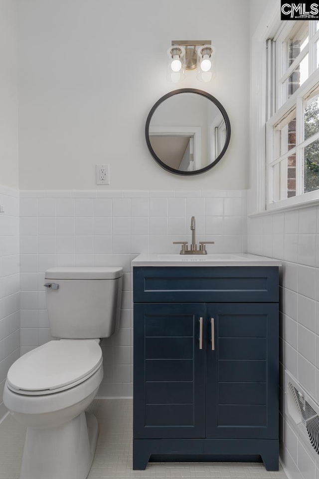 3901 Overdale Dr, Columbia, SC 29223 - bathroom with tile walls, toilet, a wainscoted wall, vanity, and tile patterned flooring