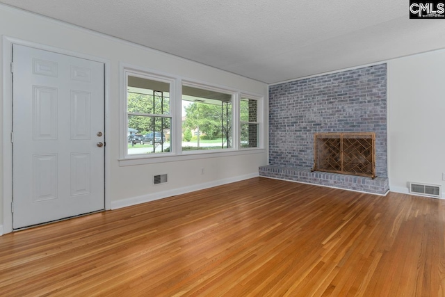 3901 Overdale Dr, Columbia, SC 29223 - unfurnished living room with light wood finished floors, baseboards, and a brick fireplace