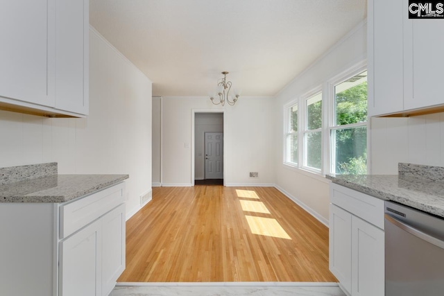 3901 Overdale Dr, Columbia, SC 29223 - kitchen with stainless steel dishwasher, light wood-style flooring, a chandelier, and white cabinetry