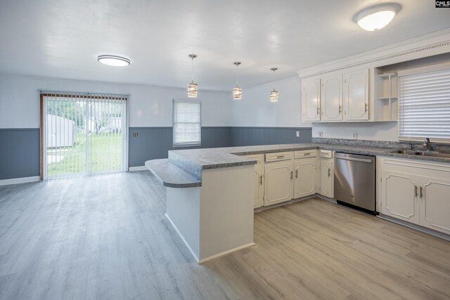 969 Boulevard Rd, Sumter, SC 29153 - kitchen featuring stainless steel dishwasher, a sink, a peninsula, light wood finished floors, and a wainscoted wall
