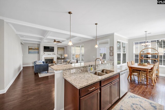 kitchen with a sink, dishwasher, dark wood-style flooring, a fireplace, and baseboards
