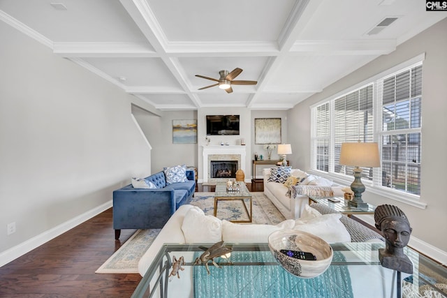 living room with baseboards, wood finished floors, coffered ceiling, a ceiling fan, and beam ceiling
