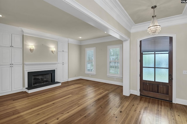 177 Preserve Ln, Columbia, SC 29209 - entrance foyer featuring wood-type flooring, ornamental molding, a chandelier, baseboards, and a fireplace with raised hearth