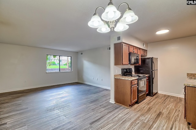 516 Menlo, Columbia, SC 29210 - kitchen with black appliances, brown cabinets, light wood-style floors, a chandelier, and baseboards
