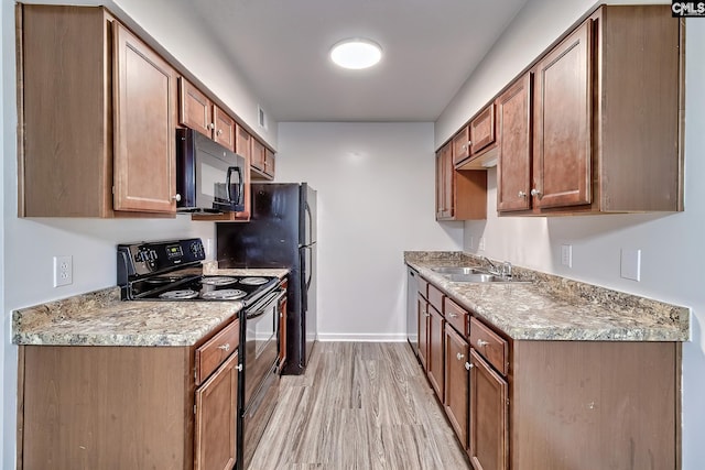 516 Menlo, Columbia, SC 29210 - kitchen featuring black appliances, a sink, light wood-type flooring, baseboards, and brown cabinets