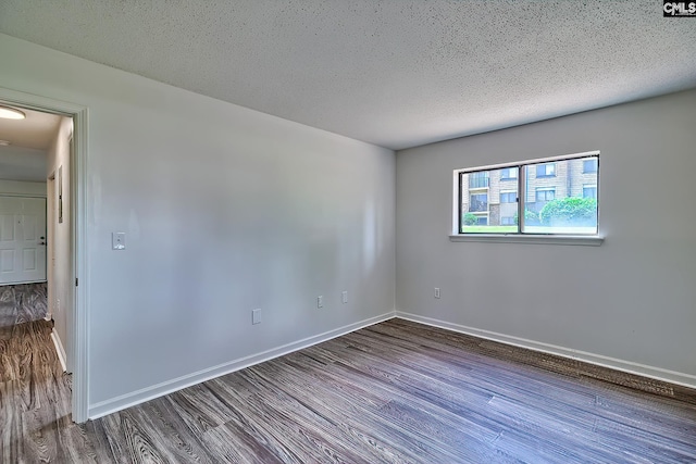 516 Menlo, Columbia, SC 29210 - empty room featuring wood finished floors, baseboards, and a textured ceiling