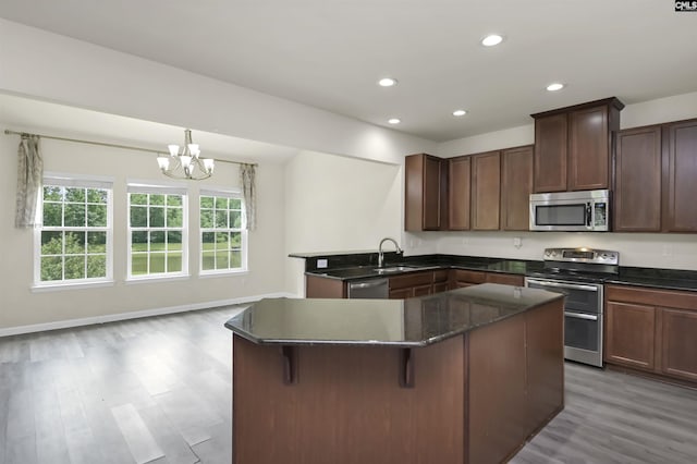 315 Merus Dr, Lexington, SC 29072 - kitchen featuring stainless steel appliances, a sink, light wood-type flooring, a center island, and a chandelier