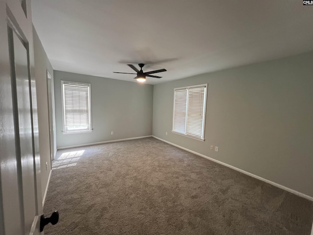 unfurnished bedroom with carpet floors, baseboards, and a ceiling fan