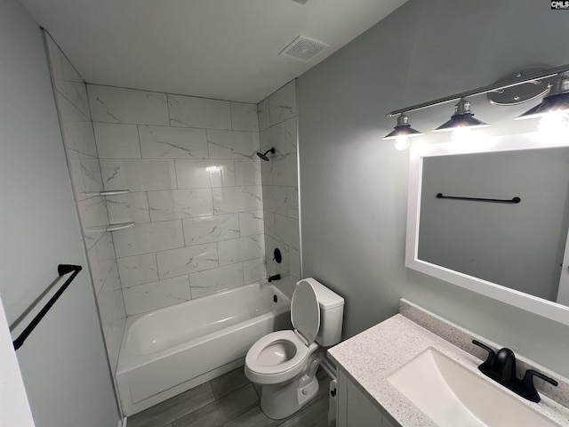 full bathroom with toilet, vanity, and shower / bathtub combination